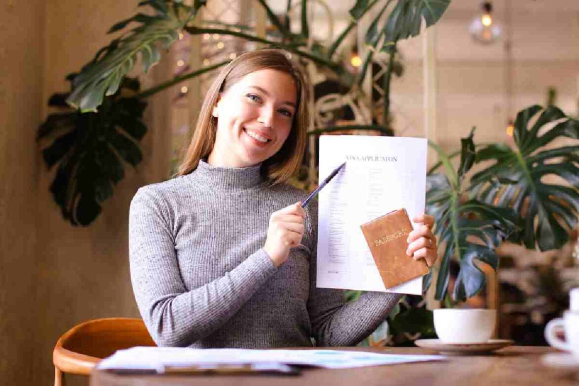 A foreign woman filling out a premium visa Thailand application form for long term residency
